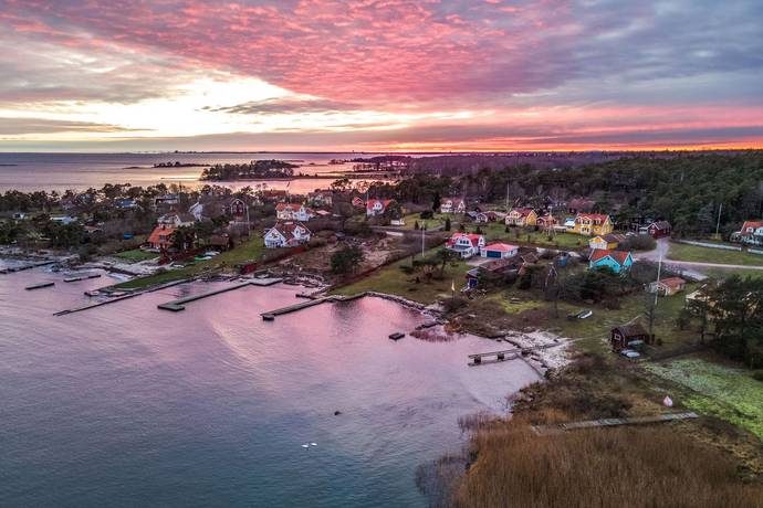 Revsudden från ovan i solnedgång, med bryggor och Kalmarsund